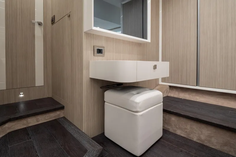 Curly Yacht Photos Pics Luxurious interior of 2021 Cranchi E52S yacht with modern vanity and seating.