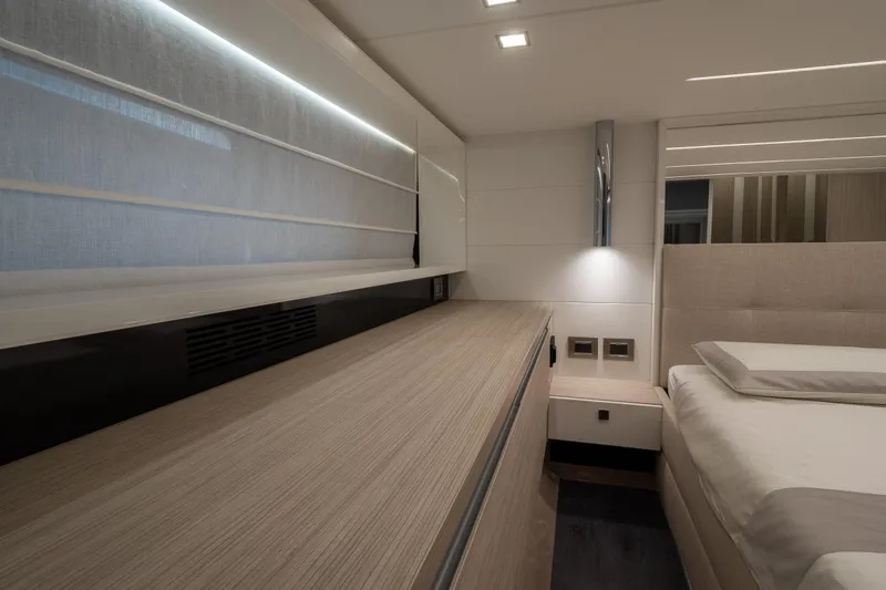 Curly Yacht Photos Pics Luxurious interior of 2021 Cranchi E52S yacht bedroom with modern design and ambient lighting.