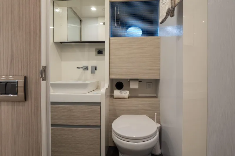 Curly Yacht Photos Pics Modern bathroom interior on 2021 Cranchi E52S yacht, featuring sleek fixtures and wood accents.