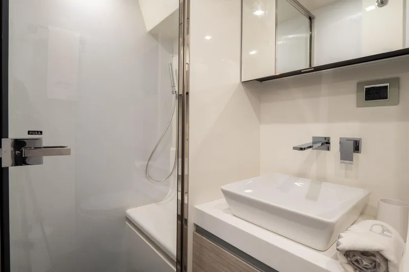 Curly Yacht Photos Pics Modern bathroom in 2021 Cranchi E52S yacht with sleek fixtures and elegant design.