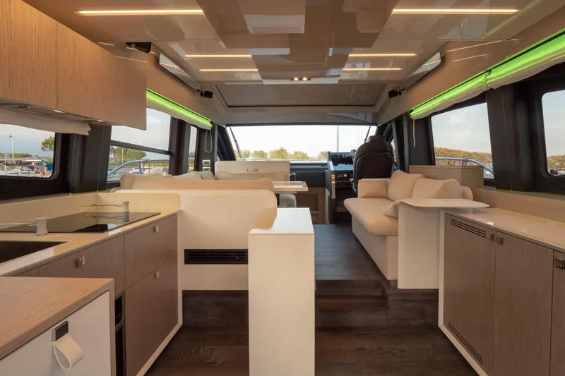 Curly Yacht Photos Pics Luxurious interior of 2021 Cranchi E52S yacht with modern kitchen and seating area.
