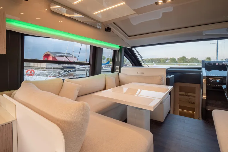 Curly Yacht Photos Pics Luxurious interior of 2021 Cranchi E52S yacht with elegant seating and modern design.