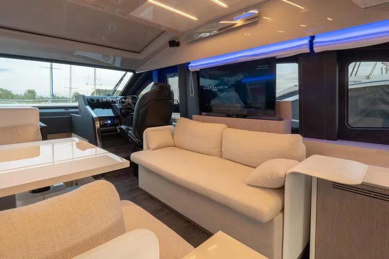 Curly Yacht Photos Pics Luxurious interior of 2021 Cranchi E52S yacht with modern seating and entertainment system.