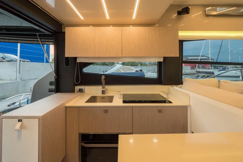 Curly Yacht Photos Pics Modern kitchen interior of 2021 Cranchi E52S yacht with sleek design and ample lighting.