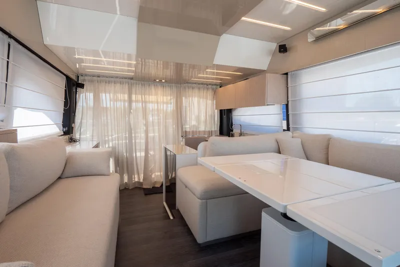 Curly Yacht Photos Pics Luxurious interior of 2021 Cranchi E52S yacht with modern seating and elegant decor.