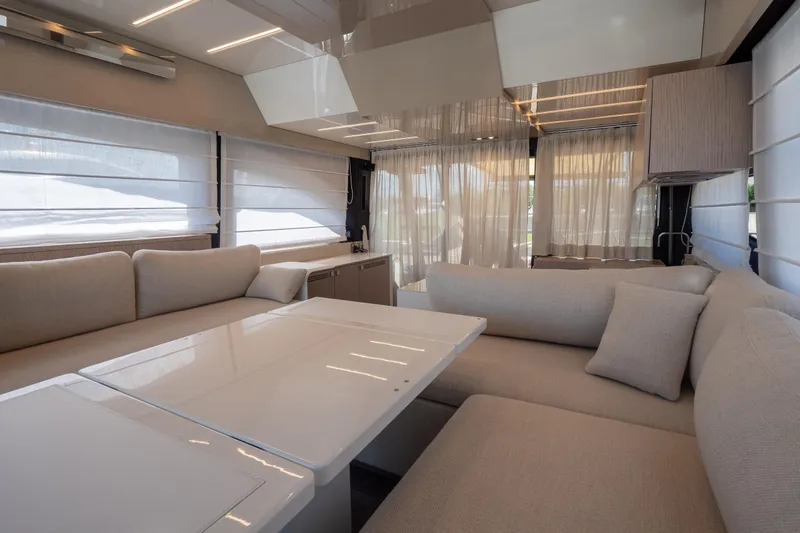 Curly Yacht Photos Pics Luxurious interior of 2021 Cranchi E52S yacht with elegant seating and modern design.
