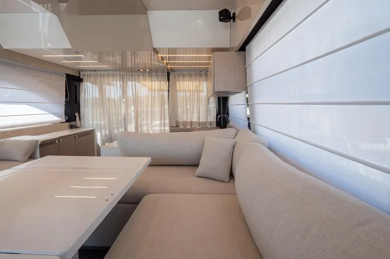 Curly Yacht Photos Pics Luxurious interior of 2021 Cranchi E52S yacht with elegant seating and modern design.
