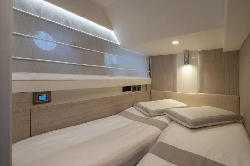 Curly Yacht Photos Pics Luxurious twin cabin interior of 2021 Cranchi E52S yacht, featuring modern design and ambient lighting.