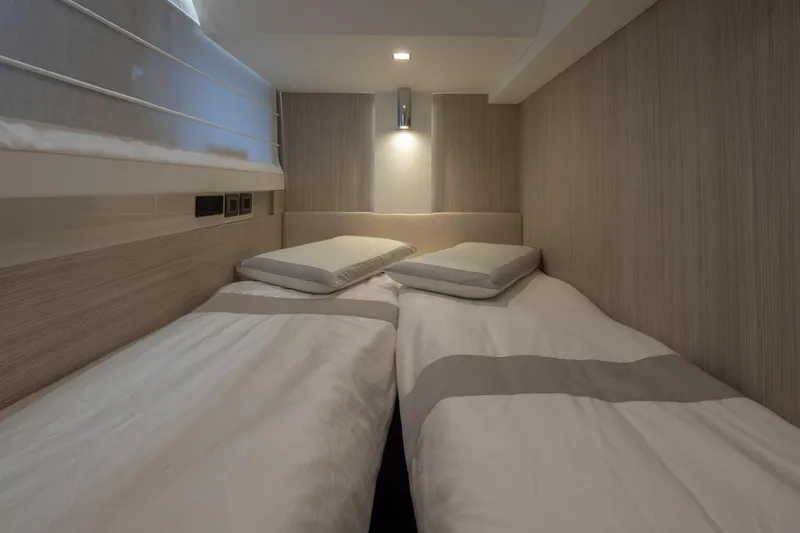 Curly Yacht Photos Pics Interior of 2021 Cranchi E52S yacht with twin beds and modern lighting.