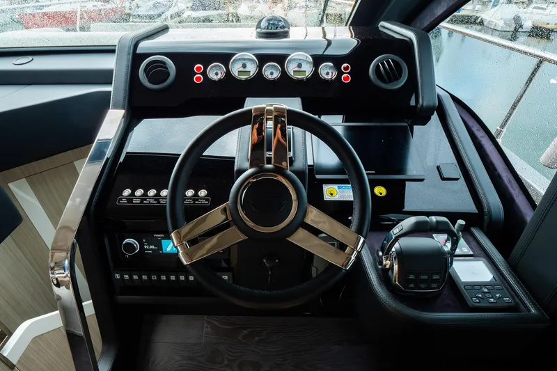 Curly Yacht Photos Pics Cockpit of 2021 Cranchi E52S yacht with modern steering wheel and control panel.