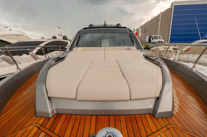 Curly Yacht Photos Pics 2021 Cranchi E52S yacht with sleek deck and luxurious sunbed.