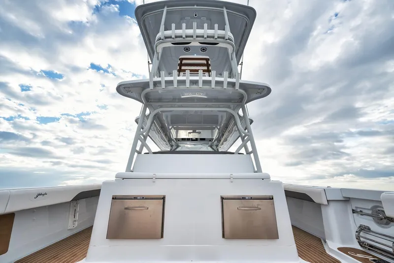  Yacht Photos Pics 2022 Yellowfin 54 Offshore boat with tower against a cloudy sky backdrop.