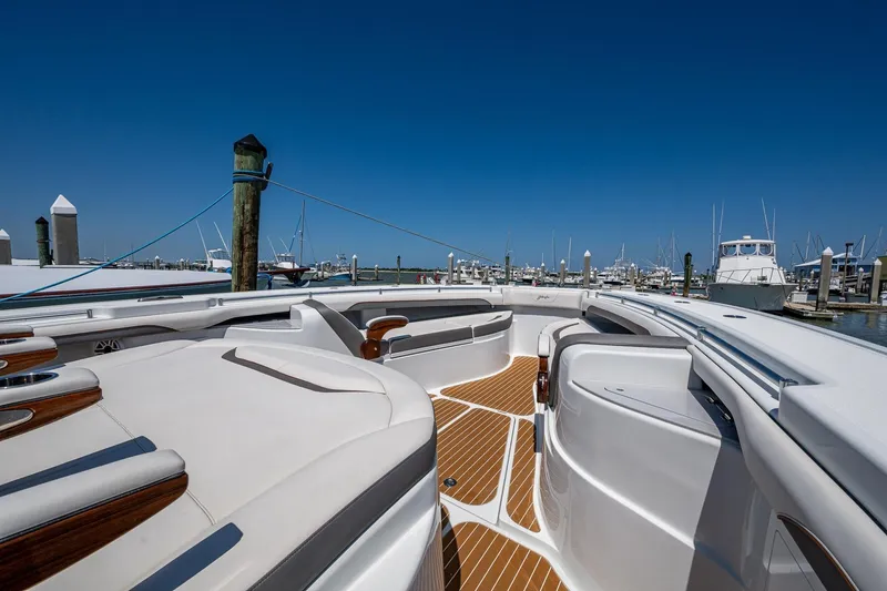  Yacht Photos Pics 2022 Yellowfin 54 Offshore boat docked at marina, featuring sleek design and spacious deck.