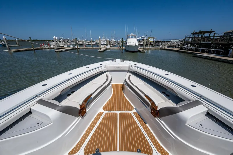  Yacht Photos Pics Yellowfin 54 Offshore 2022 boat docked at marina, featuring spacious deck and seating.