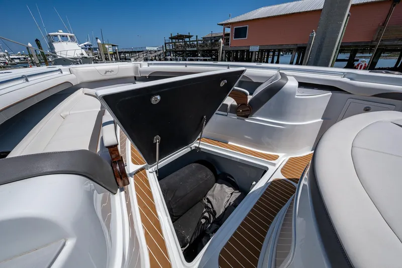  Yacht Photos Pics 2022 Yellowfin 54 Offshore boat with open storage compartment, docked at marina.