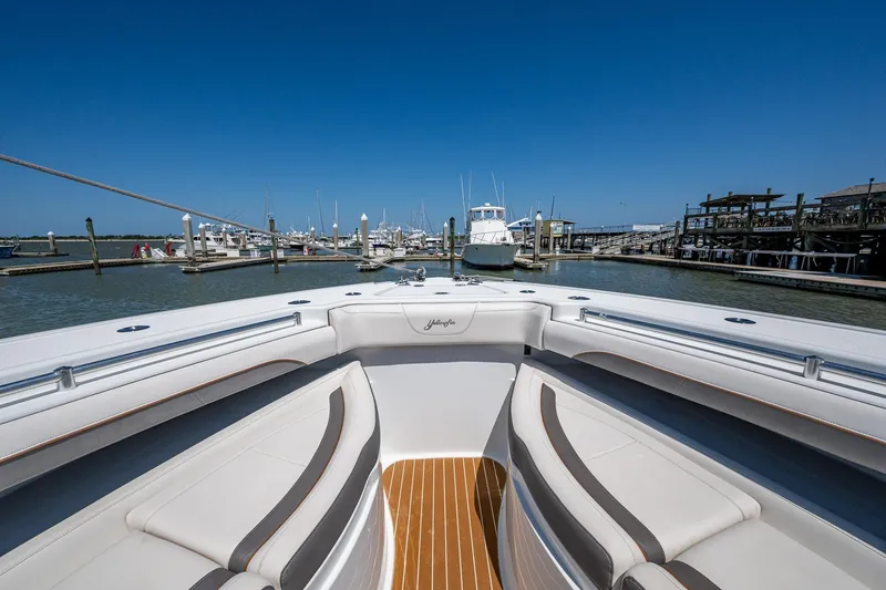  Yacht Photos Pics 2022 Yellowfin 54 Offshore boat docked at marina under clear blue sky.