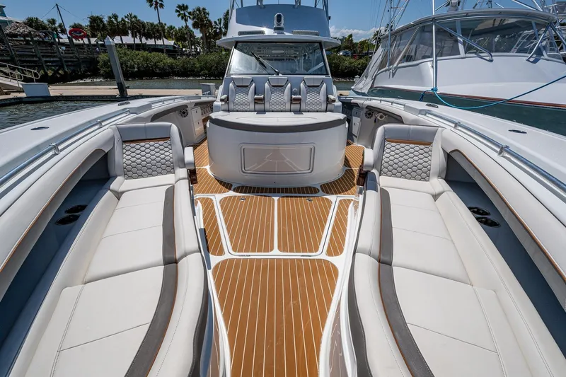  Yacht Photos Pics 2022 Yellowfin 54 Offshore boat interior with luxurious seating and teak flooring.