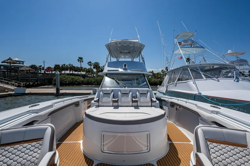  Yacht Photos Pics 2022 Yellowfin 54 Offshore boat docked, showcasing luxurious seating and sleek design.