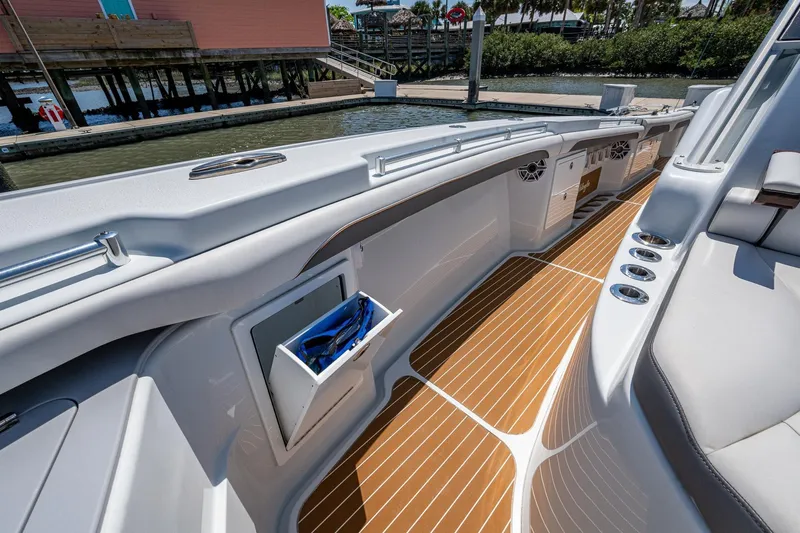  Yacht Photos Pics 2022 Yellowfin 54 Offshore boat interior with sleek design and wood-patterned flooring.