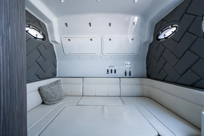  Yacht Photos Pics 2022 Yellowfin 54 Offshore cabin interior with plush seating and modern design.