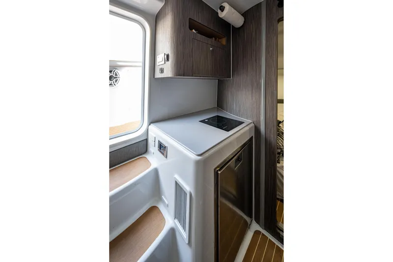  Yacht Photos Pics 2022 Yellowfin 54 Offshore interior with compact kitchen and modern design.