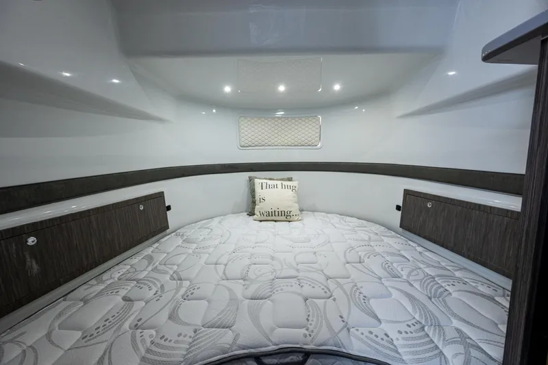  Yacht Photos Pics 2022 Yellowfin 54 Offshore cabin interior with cozy bed and decorative pillow.