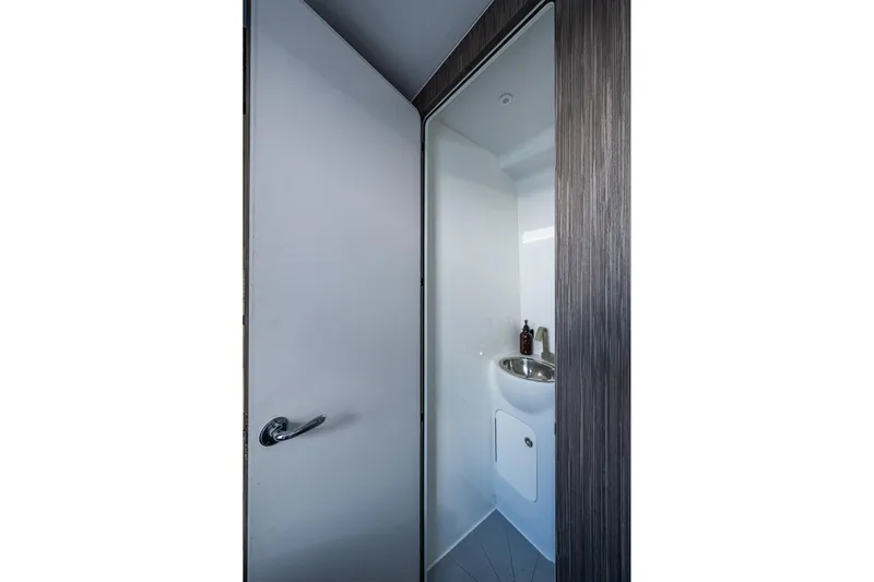  Yacht Photos Pics 2022 Yellowfin 54 Offshore boat bathroom with sleek design and modern fixtures.