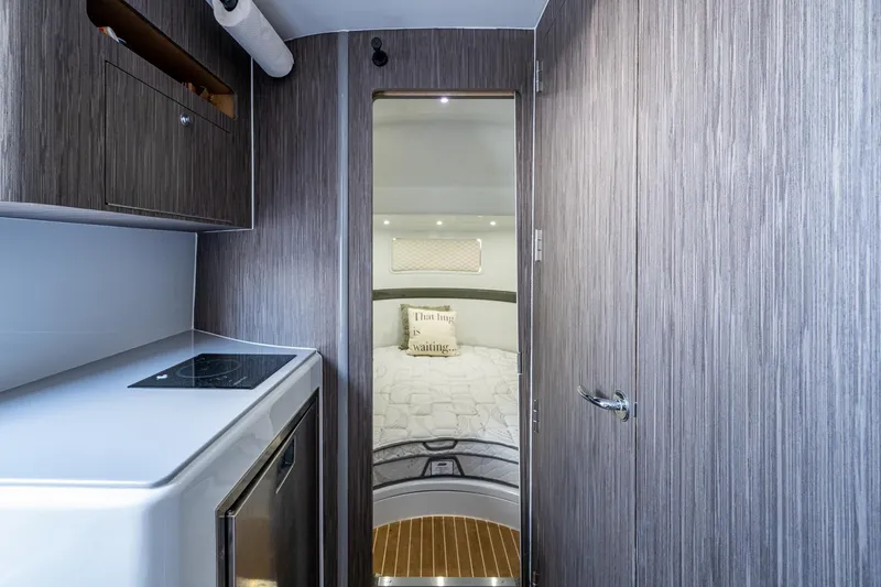  Yacht Photos Pics 2022 Yellowfin 54 Offshore interior with modern kitchen and cozy bedroom.