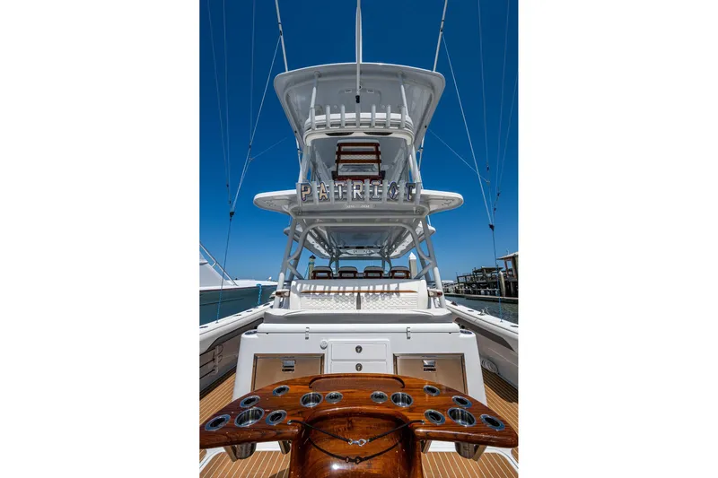  Yacht Photos Pics 2022 Yellowfin 54 Offshore boat with tower, docked under clear blue sky.