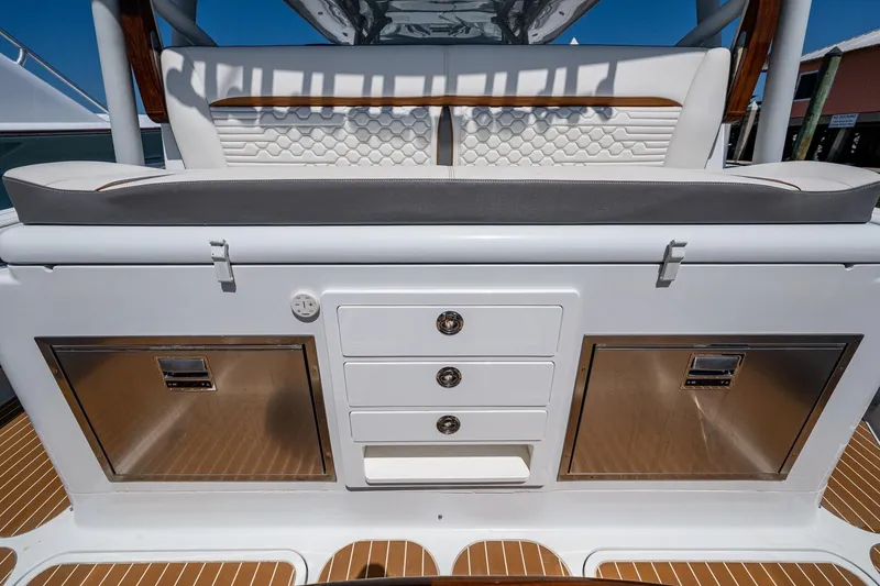  Yacht Photos Pics 2022 Yellowfin 54 Offshore boat interior with storage compartments and cushioned seating.