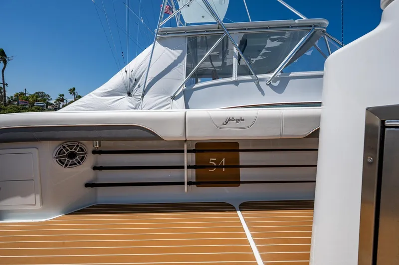  Yacht Photos Pics 2022 Yellowfin 54 Offshore boat deck with rod holders and sleek design.