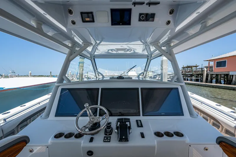  Yacht Photos Pics 2022 Yellowfin 54 Offshore boat helm with modern controls and navigation screens.