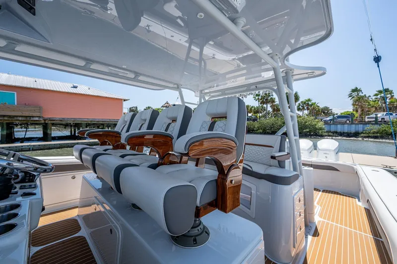  Yacht Photos Pics 2022 Yellowfin 54 Offshore boat interior with luxurious seating and helm station.