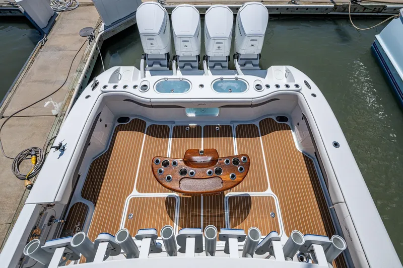  Yacht Photos Pics 2022 Yellowfin 54 Offshore boat deck with fishing rod holders and outboard motors.