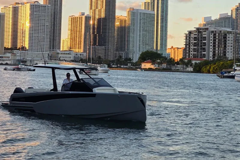 Virtue Yacht Photos Pics Modern Virtue V10 boat cruising near city skyline, 2026 model.