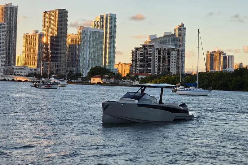 Virtue Yacht Photos Pics Luxury Virtue V10 boat on water with city skyline backdrop, 2026 model.