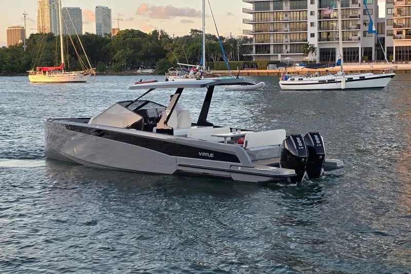 Virtue Yacht Photos Pics 2026 Virtue V10 luxury boat on water with cityscape background.