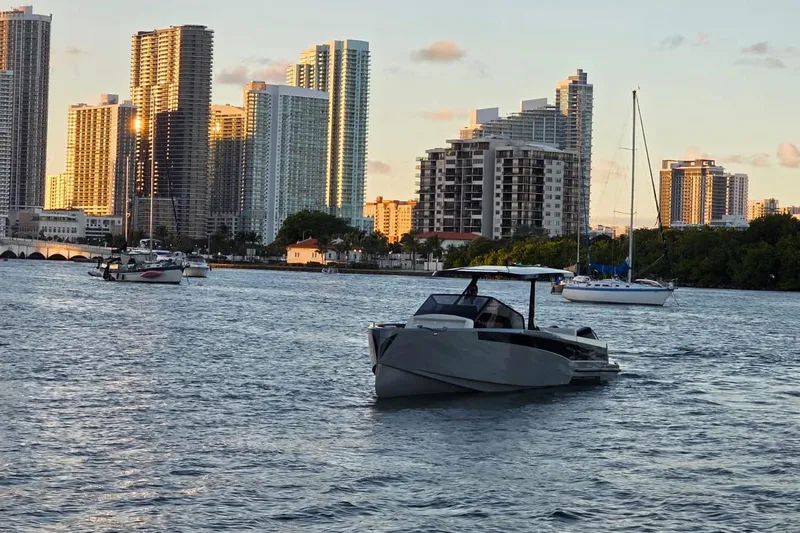 Virtue Yacht Photos Pics Modern Virtue V10 boat on water with city skyline in the background, 2026 model.