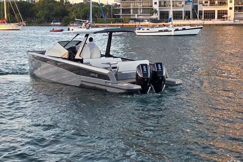 Virtue Yacht Photos Pics 2026 Virtue V10 luxury boat cruising in a scenic marina setting.