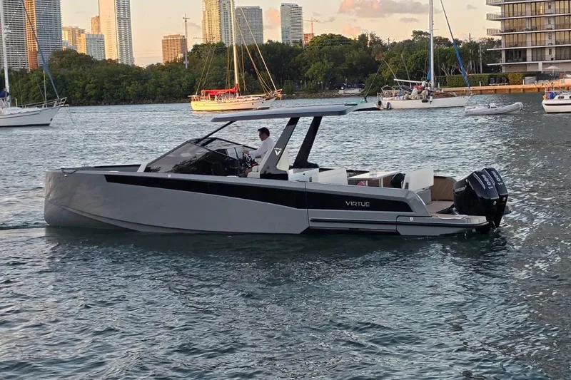 Virtue Yacht Photos Pics Modern 2026 Virtue V10 boat cruising in a scenic urban waterway.