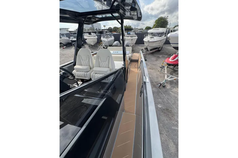 Virtue Yacht Photos Pics 2026 Virtue V10 boat with sleek design and luxurious seating at a marina.