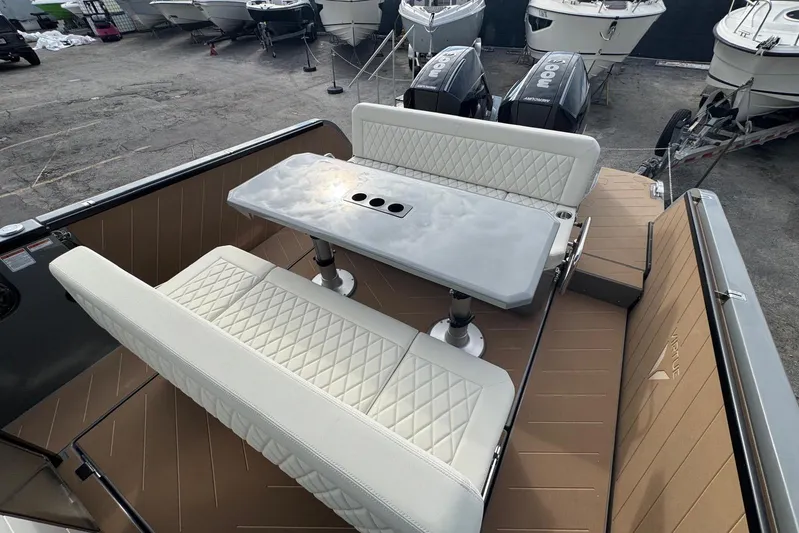 Virtue Yacht Photos Pics Luxury seating area on 2026 Virtue V10 boat with quilted upholstery and sleek table design.