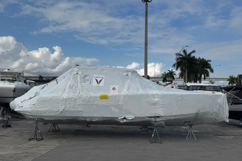 Virtue Yacht Photos Pics Covered 2026 Virtue V10 boat on stands, outdoor marina setting.