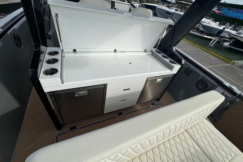 Virtue Yacht Photos Pics Luxury boat interior with kitchenette, featuring stainless steel appliances and seating. Virtue V10, 2026 model.