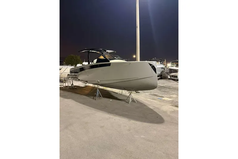 Virtue Yacht Photos Pics 2026 Virtue V10 boat displayed on stands at night.