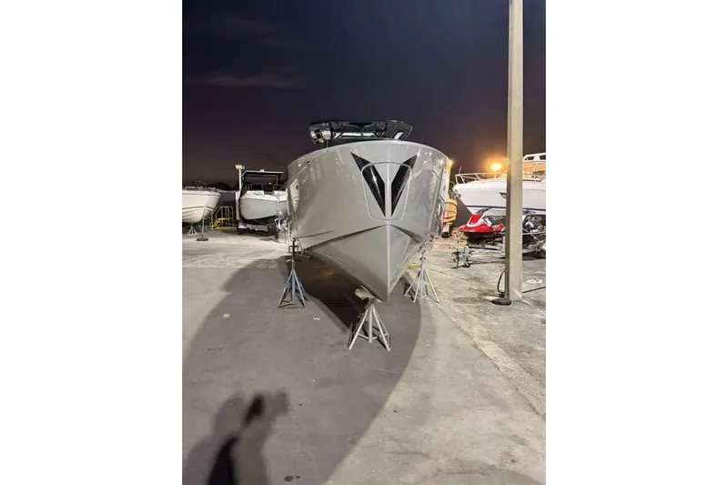 Virtue Yacht Photos Pics 2026 Virtue V10 boat on stands at night, marina setting.