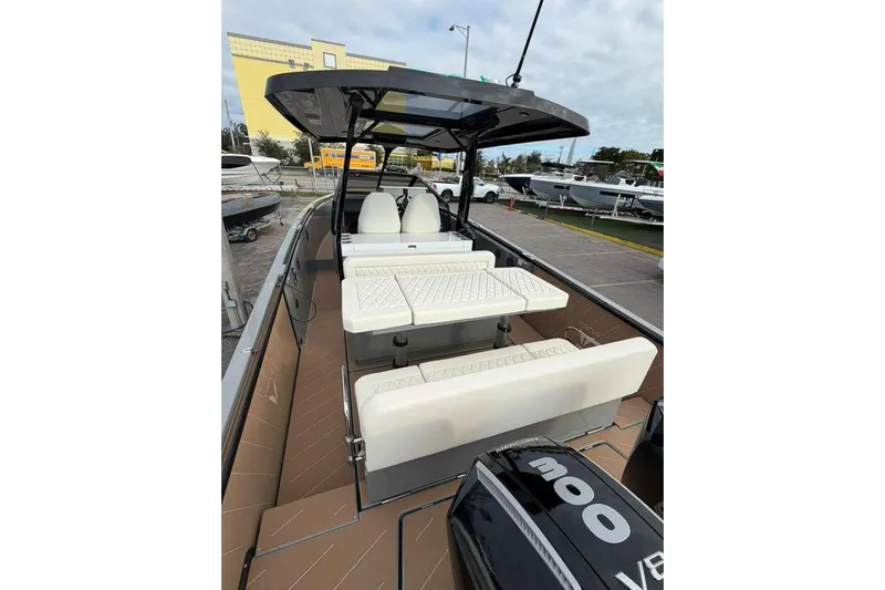 Virtue Yacht Photos Pics 2026 Virtue V10 boat with sleek seating and powerful engine at a marina.