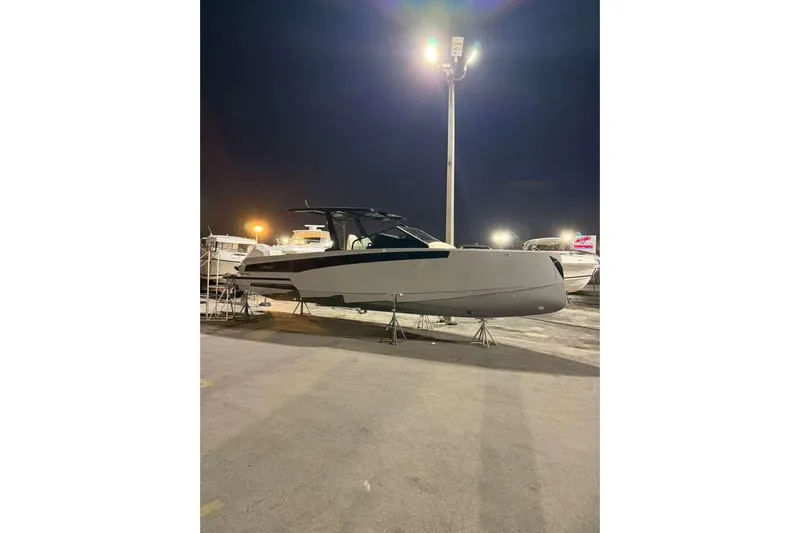 Virtue Yacht Photos Pics 2026 Virtue V10 boat displayed outdoors at night under bright lights.