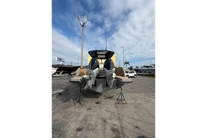 Virtue Yacht Photos Pics 2026 Virtue V10 boat with dual engines on display in a marina.