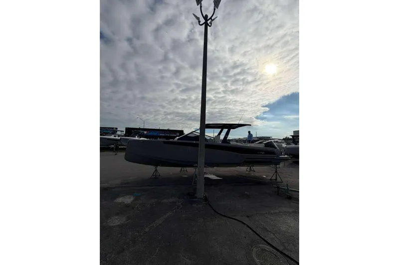 Virtue Yacht Photos Pics 2026 Virtue V10 boat on display under cloudy sky.